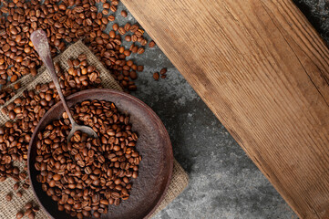 roasted coffee beans in an old vintage frying pan top shot. copy space