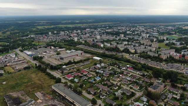 Private houses and block apartment building in distance, aerial drone view