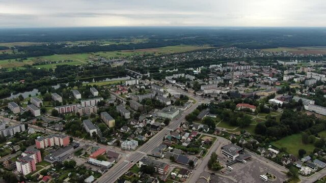 Main street and Soviet style apartment block buildings in Jonava city, aerial drone view