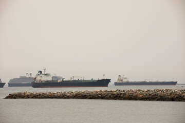 Fototapeta na wymiar Cargo vessels anchor off the California coast.