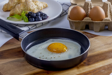 Home made croissant breakfast with fried eggs
