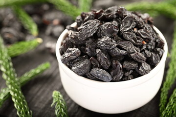 Bowl of healthy vegan  snack foods-  sun dried black raisins.