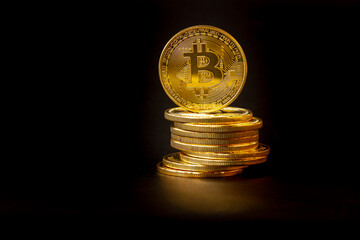 A pile of Bitcoins that have a gold color that is currently popular and has an increasing value compared to the US Dollar. For payment, finance, investment and economy concepts