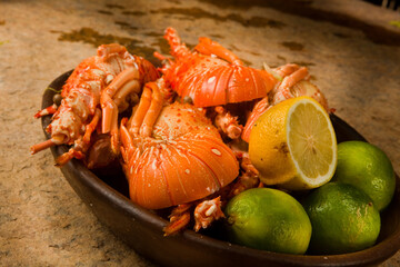 Delicious fresh and cooked whole lobster with lime, lemon on a banana leaf. High quality photo