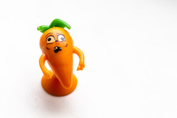 Small figurine of carrots on a white background close-up.