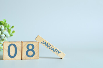 January 8, Calendar cover design with number cube with green fruit on blue background.