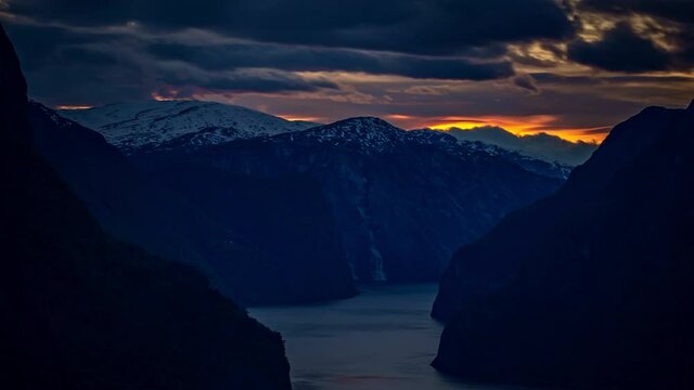 dark evening nature timelapse. Mountain range and fiord on Flam valley, in Norway
