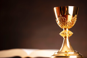 All Saints day. Catholic religion concept. The Cross,  Holy Bible and golden chalice on the altar. 