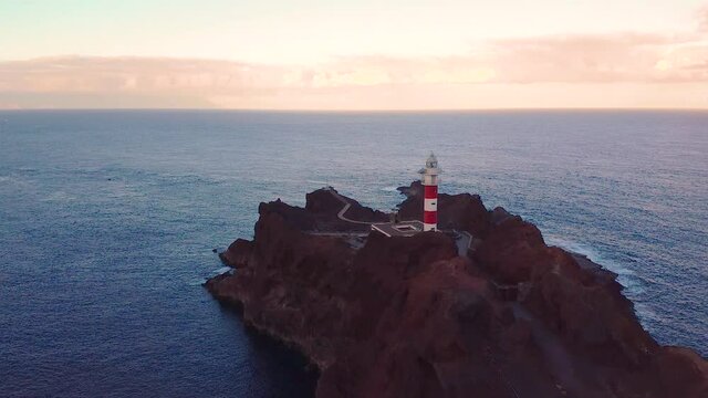Sunset over La Punta de Teno lighthouse on tenerife Island in Spain. Drone flyover