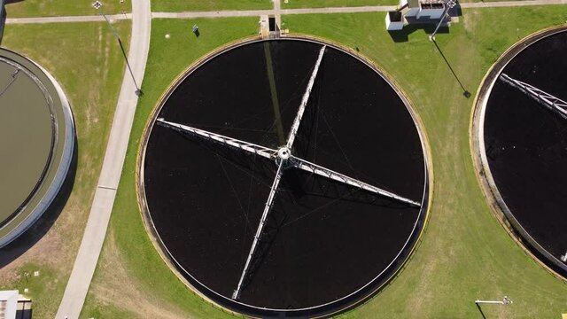 Large circular chambers of water at purification plant. Aerial.