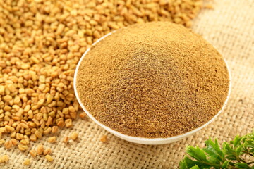 Bowl of organic fenugreek powder, Indian spices.