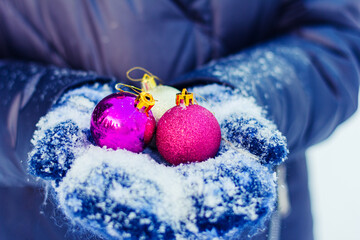 Christmas decoration ball in snowy hands