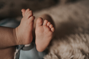 baby feet on a beige background. Baby