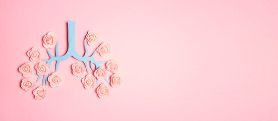 Symbol lungs made of paper and flowers on a pink background. Copy space for text.