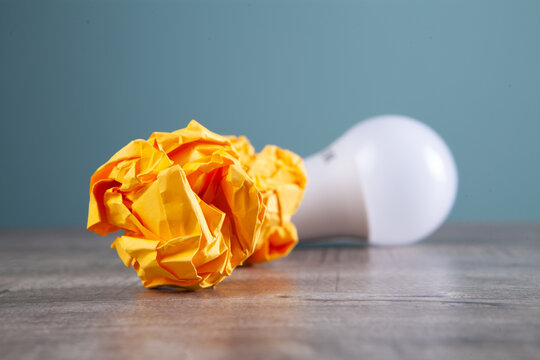 crumpled papers and a light bulb on the table