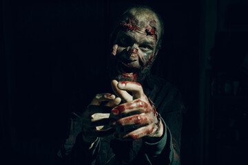 Zombie male attacking. Halloween concept. Make up skin and blood face