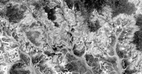   abstract photography of the deserts of Africa from the air in black and white, aerial view of...