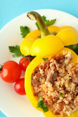 Stuffed pepper in plate on blue background,top view