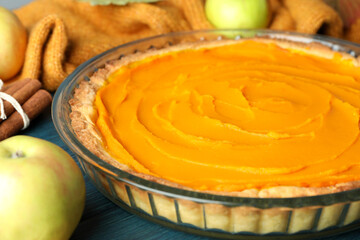 Concept of tasty food with pumpkin pie on wooden background