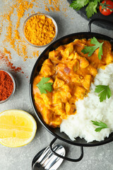 Concept of tasty food with chicken tikka on gray textured background