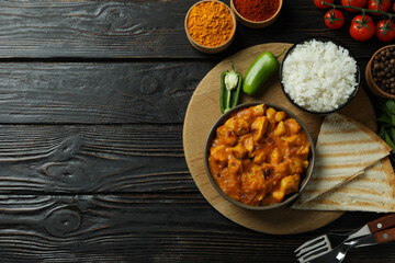 Concept of tasty food with chicken tikka on wooden background