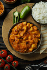 Concept of tasty food with chicken tikka on wooden background