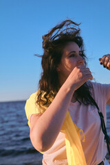 Portrait of beautiful brown-haired woman on background of sea