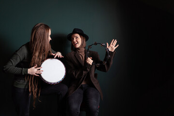 Percussion music band. Pretty young women playing bongo and singing song.