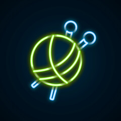 Glowing neon line Yarn ball with knitting needles icon isolated on black background. Label for hand made, knitting or tailor shop. Colorful outline concept. Vector