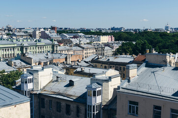 Fototapeta premium RUSSIA, Saint Petersburg: Scenic aerial cityscape view of the sunny city roofs and architecture with blue clear sky