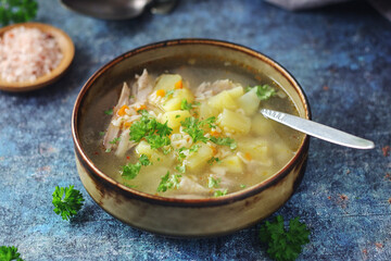 A bowl with chicken soup with pasta