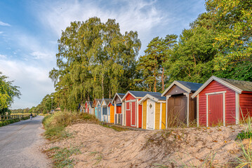 Fototapeta na wymiar scenic beach huts in a row in the sand close to the sea