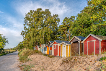 cute beach huts in a row in the sand