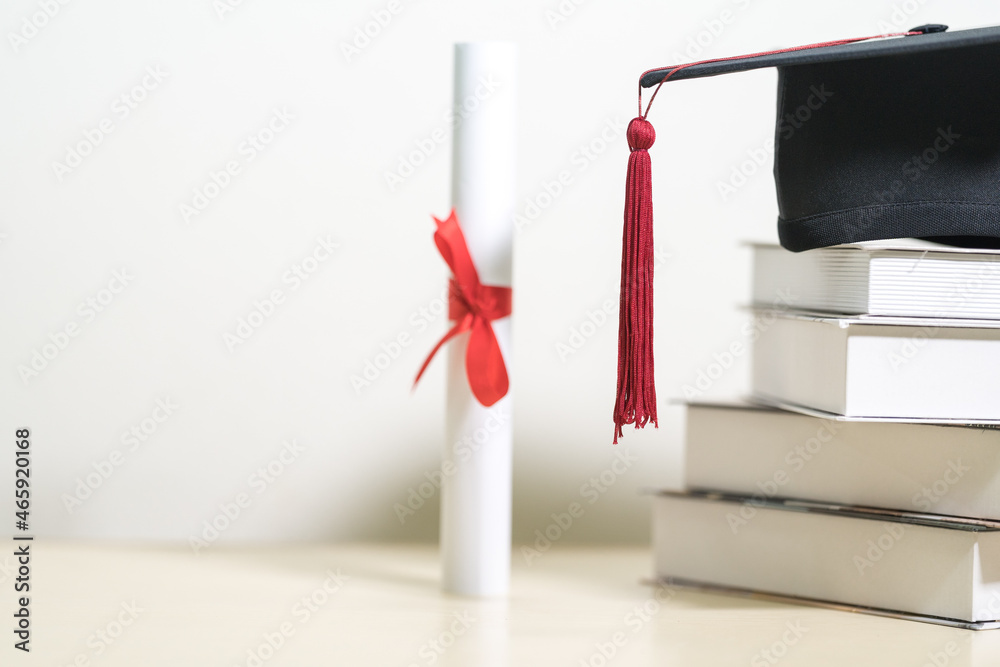 Wall mural Close-up of a mortarboard and degree certificate on the table. Education Concept Stock Photo - Wall murals