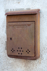 very old rusty letterbox on the wall