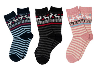 three pairs of woolen socks with cute christmas pattern isolated on white background