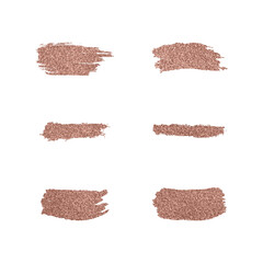 A set of shiny roze gold glitter brushstrokes. Christmas glowing decorations. © julia_khimich
