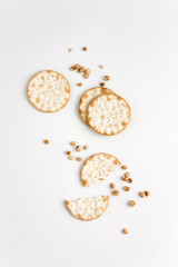 Crackers and grains on white background