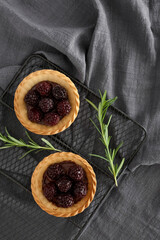 Blackberry tart and rosemary on a cooling rack