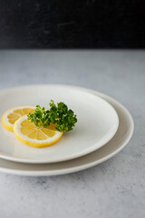 Lemon slices with parsley on the plate