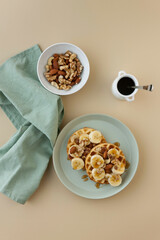 Waffles with bananas and nuts toppings