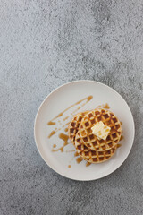 Waffles with butter and syrup on it