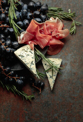 Prosciutto with blue cheese, grapes, and rosemary.