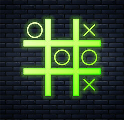 Glowing neon Tic tac toe game icon isolated on brick wall background. Vector