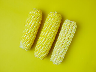 peeled corn isolated on a yellow background. for the concept of healthy food and vegetables. flat lay look