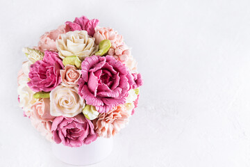 Bouquet of zefir flowers on a light background.