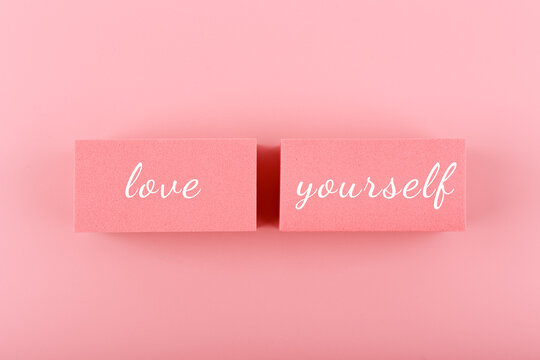 Self love and mental health minimal creative concept in pink colors against pink background. Text on pink background