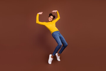 Fototapeta na wymiar Full body photo of teen girl have fun wear jumper jeans footwear isolated on brown color background