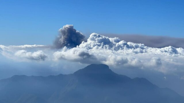 View of the erupting volcano on the island of La Palma, Spain from behind the clouds 