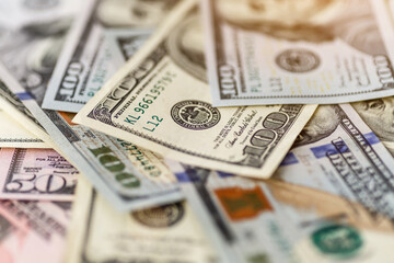 Money american hundred dollar bills.Closeup of assorted American banknotes.US currency scattered on the table.america currency dollor currency.World economic crisis associated with coronovirus.